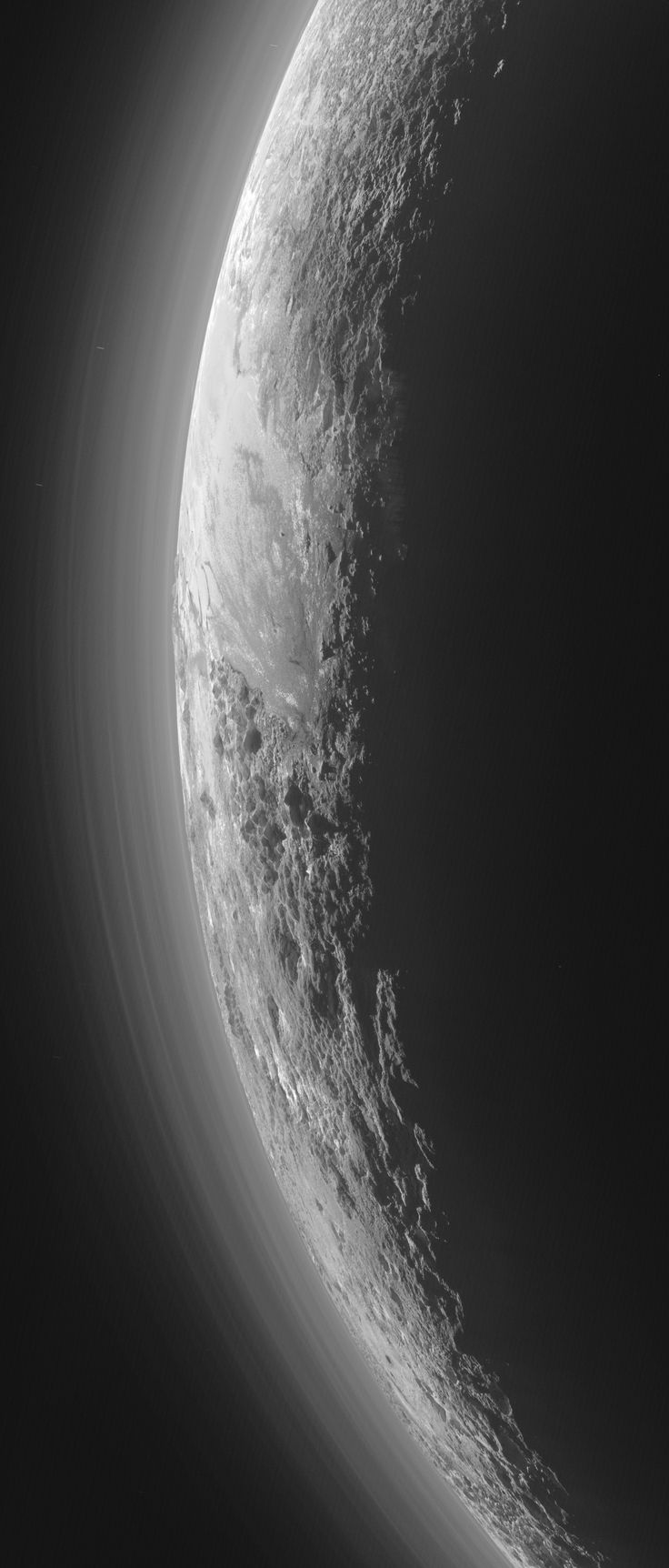 Only 15 minutes after its closest approach to Pluto on July 14, 2015, NASAs New Horizons spacecraft looked back toward the sun and captured this near-sunset view of the rugged, icy mountains and flat ice plains extending to Plutos horizon. The smooth expanse of the informally named icy plain Sputnik Planum (right) is flanked on the left by rugged mountains up to 11,000 feet (3,500 meters) high, including the informally named Norgay Montes in the foreground and Hillary Montes on the