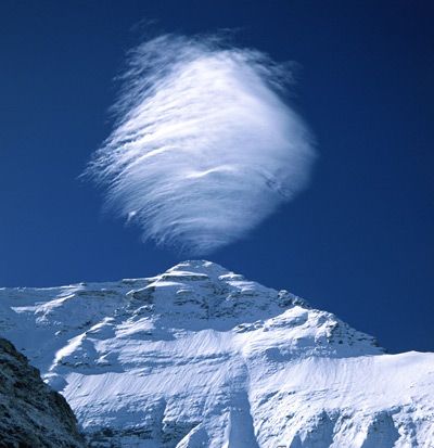 Mount Everest is so tall that it interferes with the clouds that pass by. Here a lenticular cloud forms above its peak. #science #nature
