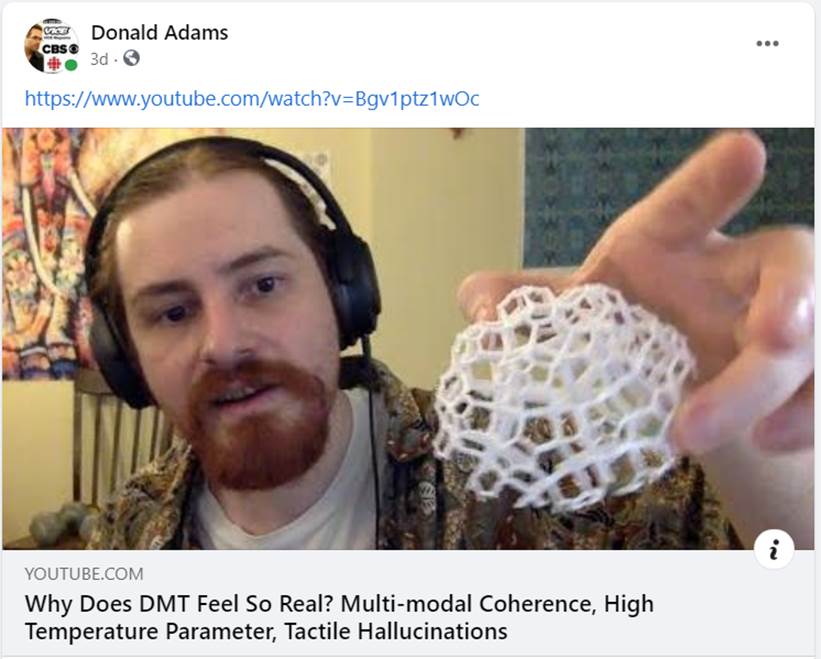 A person wearing headphones and holding a white object

Description automatically generated with medium confidence